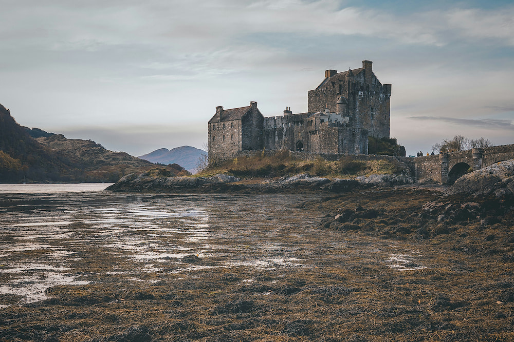 Exterior of an ancient vampire mansion emerging above the water