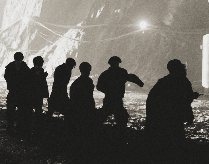 News-style illustration of a vampire couple interrupted mid-ritual as red sirens flare in the background.