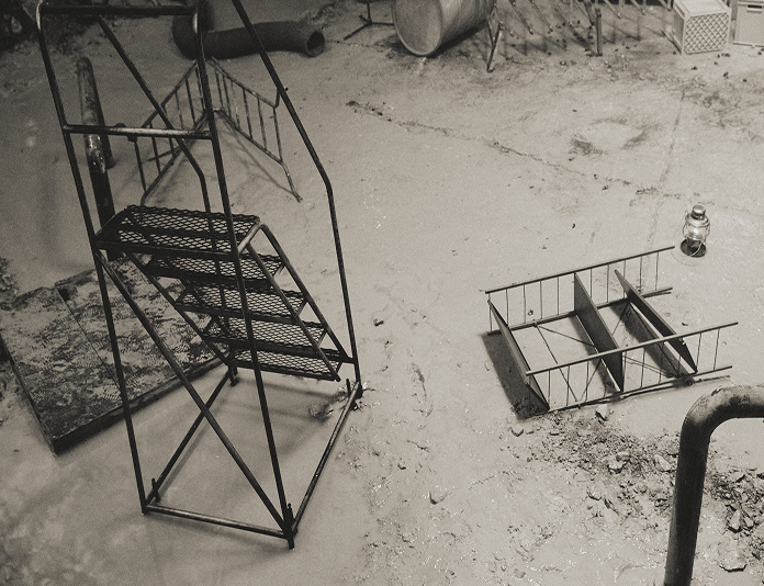 Silhouettes of a vampire couple and a human woman walking across a blazing desert under a blood-red sky.